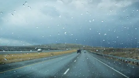 Fotografía de archivo de conducción en un día de lluvia